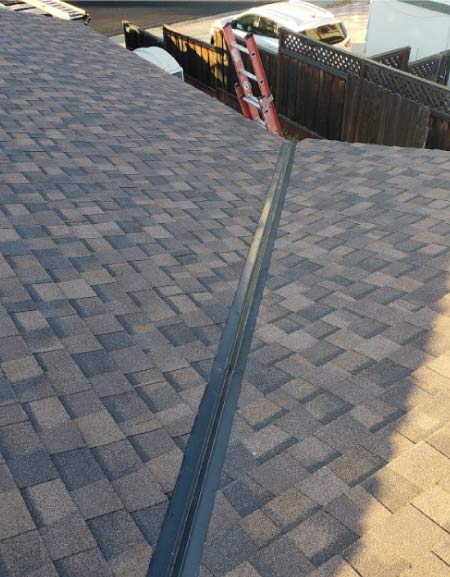 roofing-maintenance quality gray architectural shingle roof with stair behind