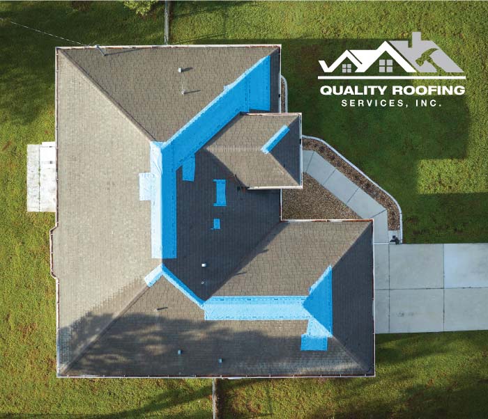 Precision emergency roof tarping applied to the critical valleys and ridges of a brown shingle roof by a licensed roofing contractor to stop active leaks during the rainy season in Contra Costa County.